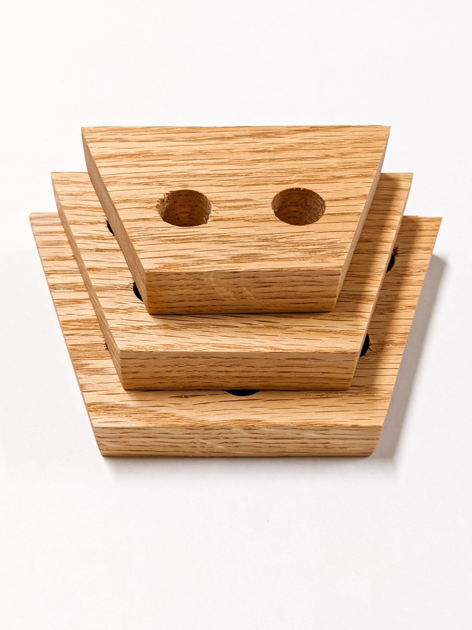 A set of three trapezoid propagation shelves sit one on top of the other with the largest at the bottom and the smallest on top.